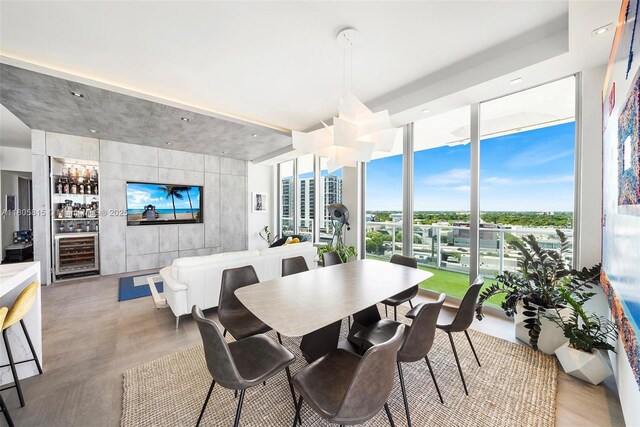 3470 E Coast Ave Unit H1201, Miami, FL 33137 - dining area featuring wine cooler, healthy amount of natural light, a bar, and expansive windows