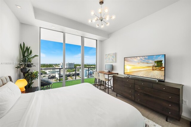3470 E Coast Ave Unit H1201, Miami, FL 33137 - bedroom with a chandelier, expansive windows, and access to exterior