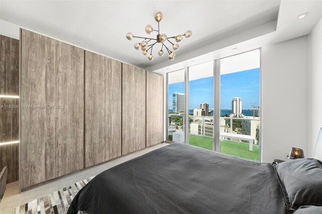 3470 E Coast Ave Unit H1201, Miami, FL 33137 - bedroom featuring a view of city, a chandelier, access to exterior, and expansive windows