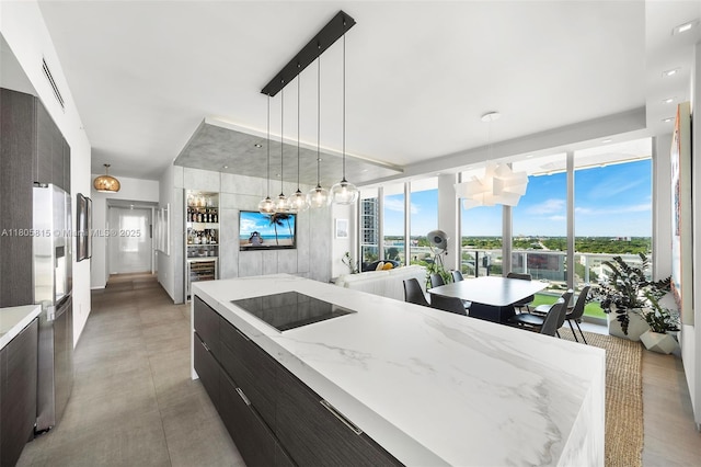 3470 E Coast Ave Unit H1201, Miami, FL 33137 - kitchen with modern cabinets, expansive windows, pendant lighting, and light stone counters