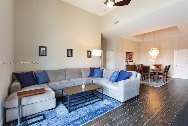 8395 SW 73rd Ave Unit 312, Miami, FL 33143 - living area with a chandelier, wood tiled floors, a towering ceiling, ceiling fan, and baseboards
