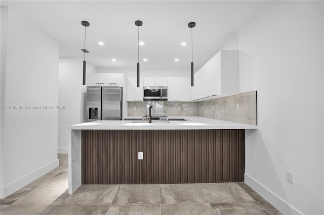 3431-3433 SW 16th Ter, Miami, FL 33145 - kitchen with stainless steel appliances, light countertops, a peninsula, baseboards, and white cabinets