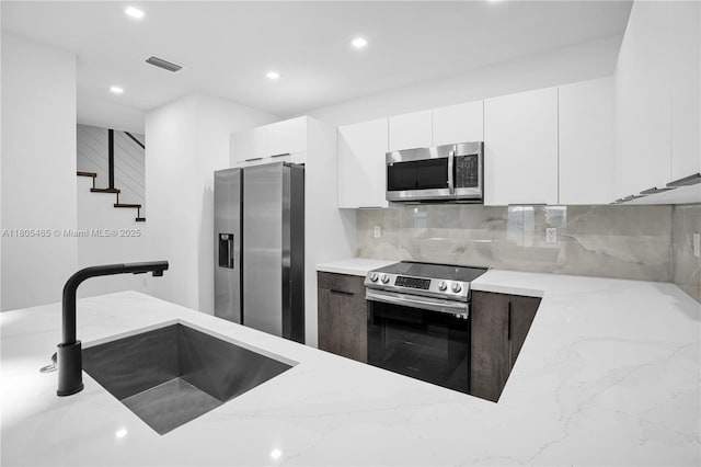 3431-3433 SW 16th Ter, Miami, FL 33145 - kitchen with stainless steel appliances, a sink, light stone countertops, recessed lighting, and backsplash