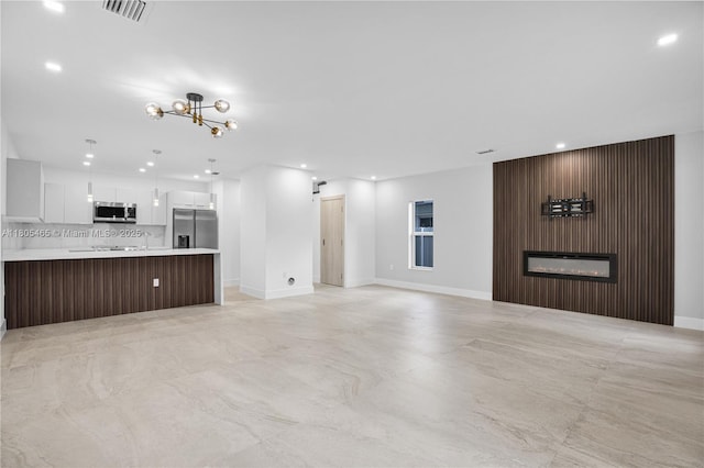 3431-3433 SW 16th Ter, Miami, FL 33145 - unfurnished living room with a glass covered fireplace, baseboards, recessed lighting, and a chandelier