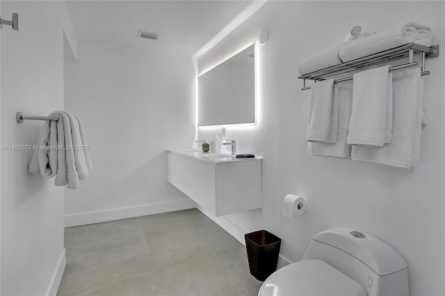 2345 SW 16th St, Miami, FL 33145 - bathroom featuring baseboards, toilet, and vanity