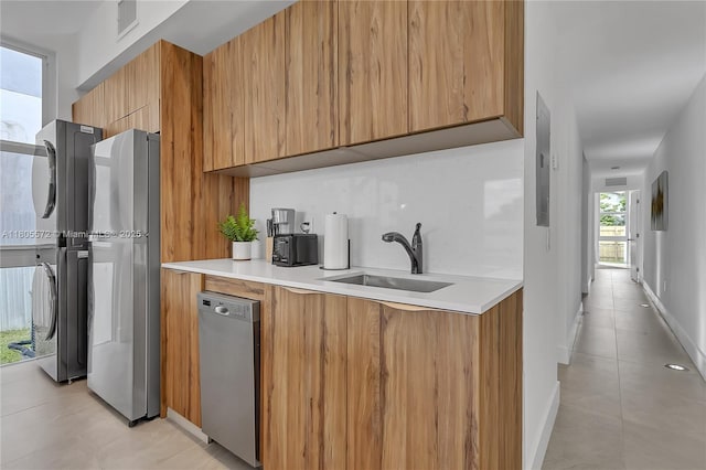 2345 SW 16th St, Miami, FL 33145 - kitchen with a sink, stainless steel appliances, estacked washer and dryer, modern cabinets, and light countertops