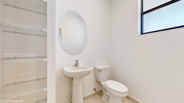 10004 SW 231st Ln, Miami, FL 33190 - bathroom featuring toilet, tile patterned floors, and baseboards