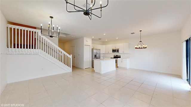 10004 SW 231st Ln, Miami, FL 33190 - unfurnished living room with a chandelier, stairs, light tile patterned flooring, recessed lighting, and a sink