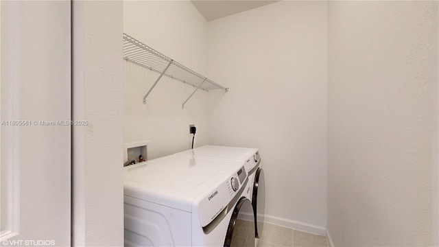 10004 SW 231st Ln, Miami, FL 33190 - laundry room with washing machine and dryer, baseboards, and light tile patterned floors