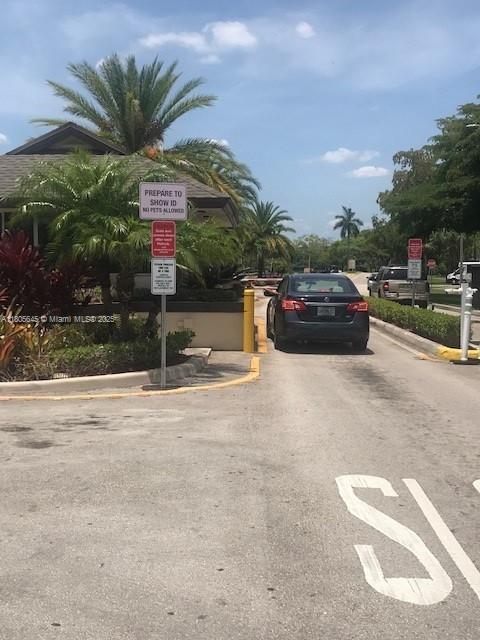 12500 SW 5th Ct Unit 210M, Pembroke Pines, FL 33027 - view of asphalt street featuring curbs and traffic signs