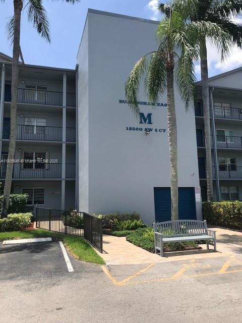 12500 SW 5th Ct Unit 210M, Pembroke Pines, FL 33027 - view of building exterior with uncovered parking