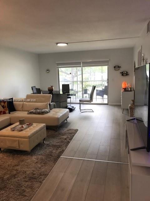 12500 SW 5th Ct Unit 210M, Pembroke Pines, FL 33027 - living room with wood finished floors and plenty of natural light