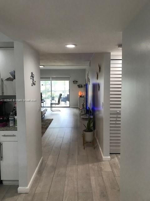 12500 SW 5th Ct Unit 210M, Pembroke Pines, FL 33027 - corridor featuring light wood finished floors and baseboards