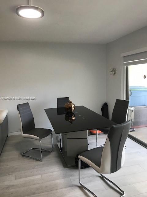 12500 SW 5th Ct Unit 210M, Pembroke Pines, FL 33027 - dining area with light wood-type flooring