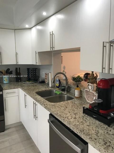 12500 SW 5th Ct Unit 210M, Pembroke Pines, FL 33027 - kitchen with dishwasher, a sink, white cabinets, light stone counters, and recessed lighting