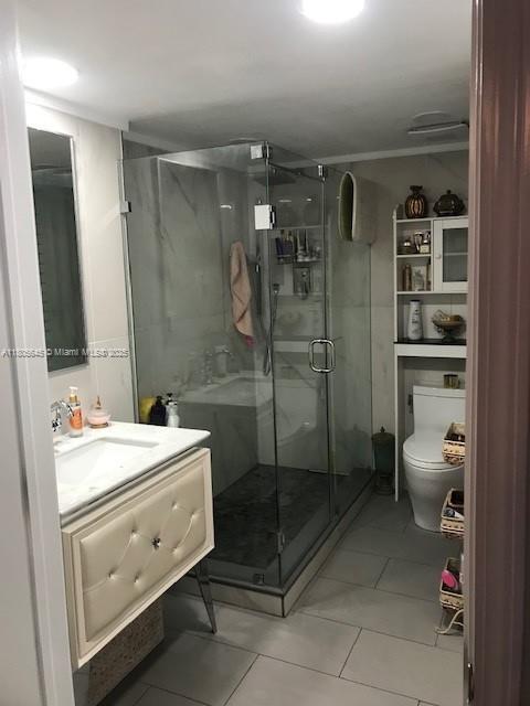 12500 SW 5th Ct Unit 210M, Pembroke Pines, FL 33027 - full bathroom with toilet, a shower stall, tile patterned floors, and vanity