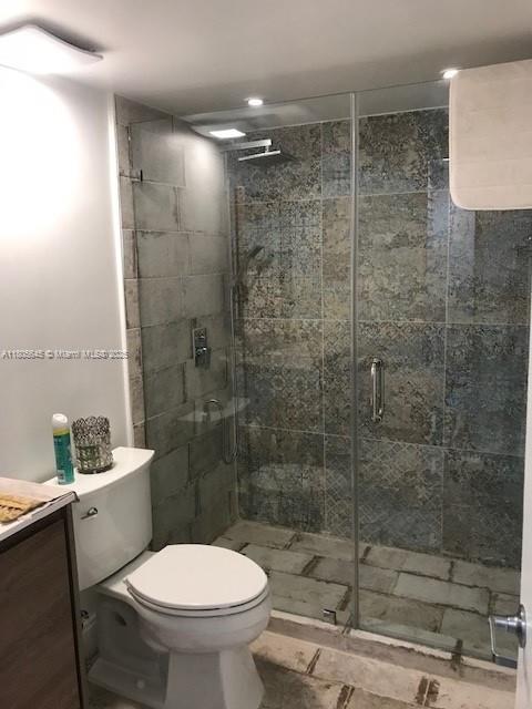 12500 SW 5th Ct Unit 210M, Pembroke Pines, FL 33027 - bathroom featuring toilet, vanity, and a shower stall