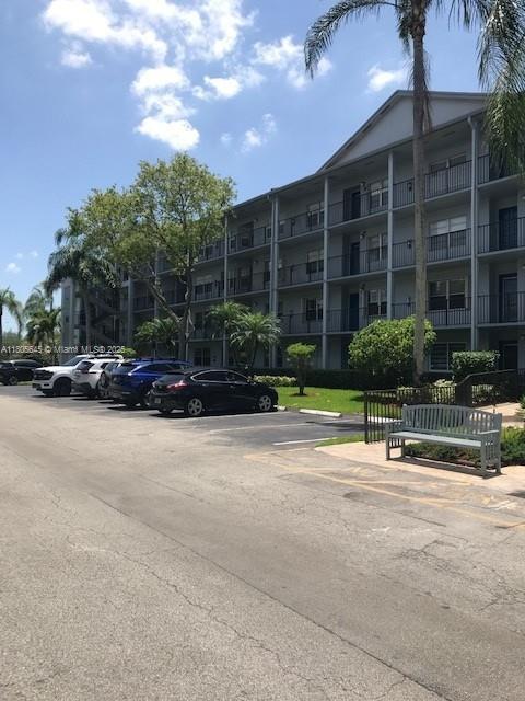 12500 SW 5th Ct Unit 210M, Pembroke Pines, FL 33027 - view of apartment building / complex with uncovered parking