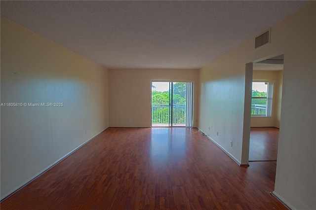 405 S Pine Island Rd Unit 405D, Plantation, FL 33324 - spare room with dark wood finished floors, baseboards, and a textured ceiling