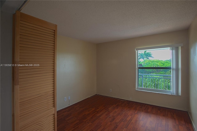 405 S Pine Island Rd Unit 405D, Plantation, FL 33324 - unfurnished bedroom with dark wood-type flooring, a closet, and a textured ceiling