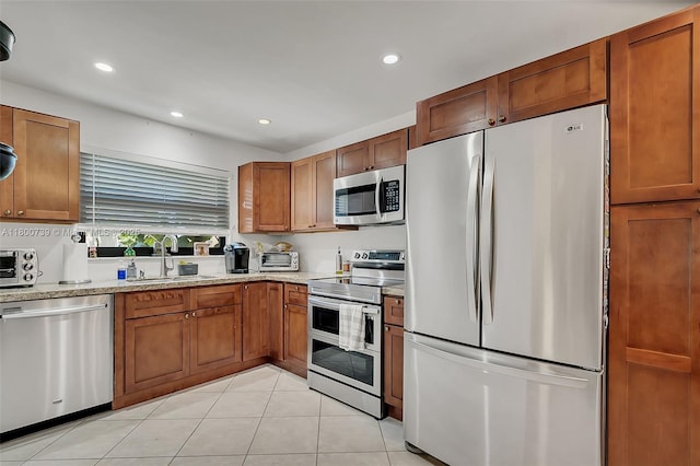 1541 NW 92nd Ave Unit 186, Pembroke Pines, FL 33024 - kitchen with appliances with stainless steel finishes, a sink, recessed lighting, brown cabinets, and light tile patterned floors