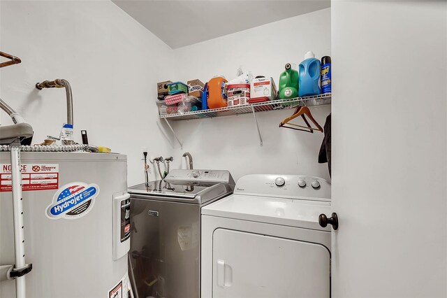 1541 NW 92nd Ave Unit 186, Pembroke Pines, FL 33024 - washroom with water heater and washer and clothes dryer