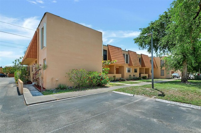 1541 NW 92nd Ave Unit 186, Pembroke Pines, FL 33024 - view of building exterior featuring uncovered parking
