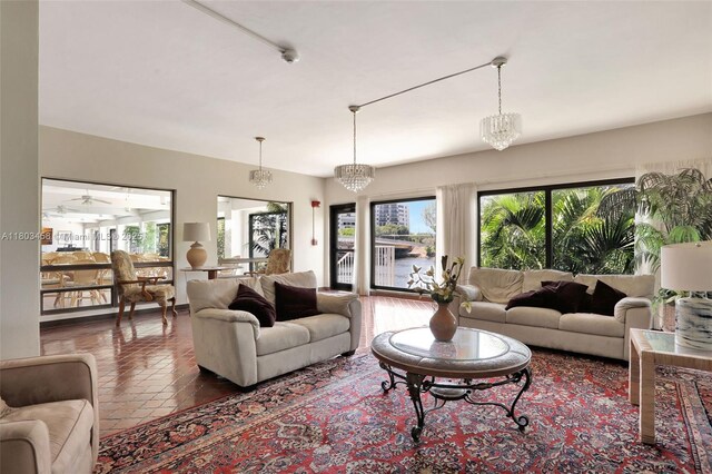 1401 N Riverside Dr Unit 1403, Pompano Beach, FL 33062 - living room with healthy amount of natural light, tile patterned flooring, and a chandelier