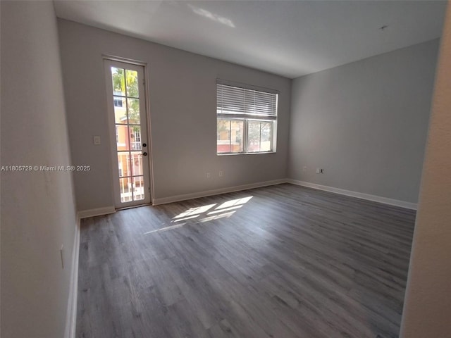 unfurnished room featuring wood finished floors and baseboards