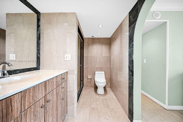 2655 Collins Ave Unit 1501, Miami Beach, FL 33140 - full bathroom with tile walls, toilet, vanity, tile patterned flooring, and recessed lighting