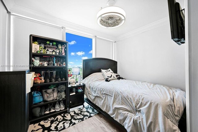 2655 Collins Ave Unit 1501, Miami Beach, FL 33140 - bedroom with crown molding and wood finished floors