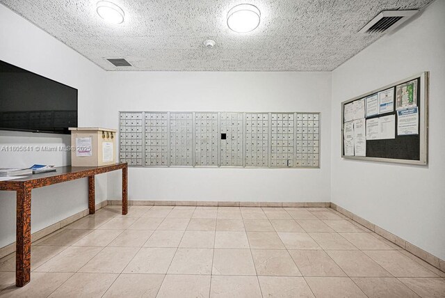 2655 Collins Ave Unit 1501, Miami Beach, FL 33140 - empty room featuring mail area, tile patterned flooring, and baseboards