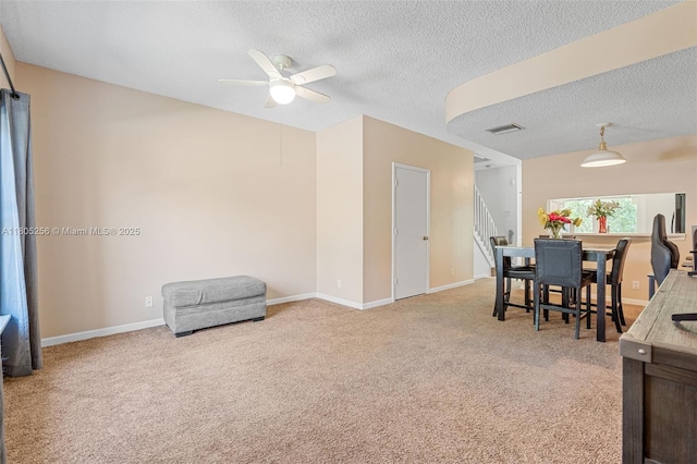 9808 NW 56th Pl, Coral Springs, FL 33076 - carpeted living room featuring a textured ceiling, a ceiling fan, stairs, and baseboards