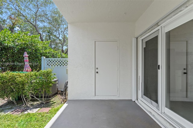9808 NW 56th Pl, Coral Springs, FL 33076 - doorway to property with fence, a patio, and stucco siding