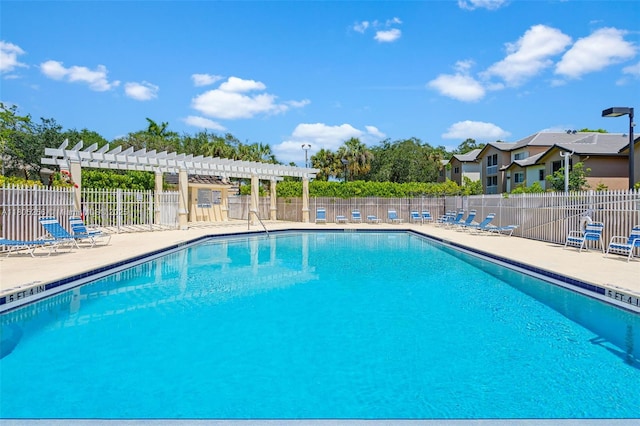 9808 NW 56th Pl, Coral Springs, FL 33076 - community pool with a pergola, fence, and a patio area