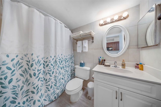 19201 Collins Ave Unit 721, Sunny Isles Beach, FL 33160 - bathroom featuring toilet, vanity, tile walls, a shower with curtain, and decorative backsplash