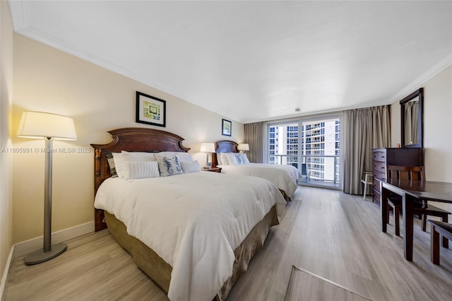 19201 Collins Ave Unit 721, Sunny Isles Beach, FL 33160 - bedroom with light wood finished floors, baseboards, and ornamental molding