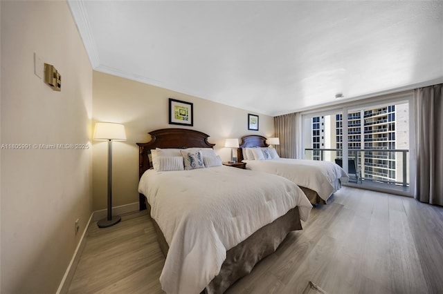 19201 Collins Ave Unit 721, Sunny Isles Beach, FL 33160 - bedroom featuring baseboards, wood finished floors, and ornamental molding
