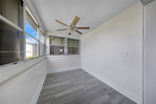 unfurnished sunroom with wood finished floors and baseboards