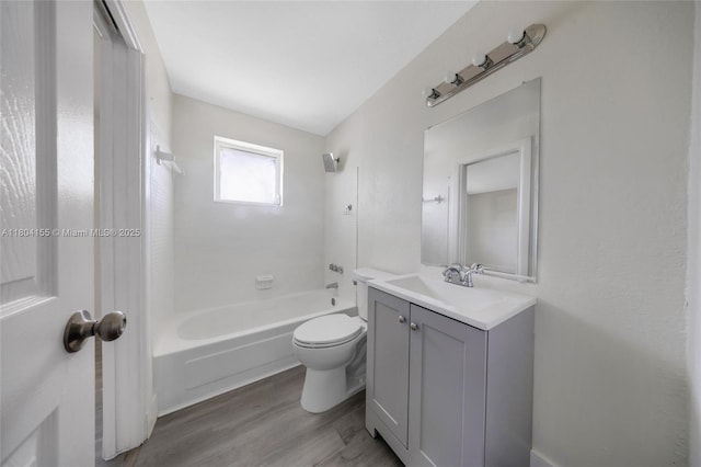 bathroom with bathing tub / shower combination, wood finished floors, toilet, and vanity