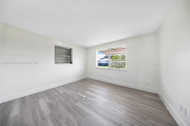 unfurnished room featuring wood finished floors and baseboards