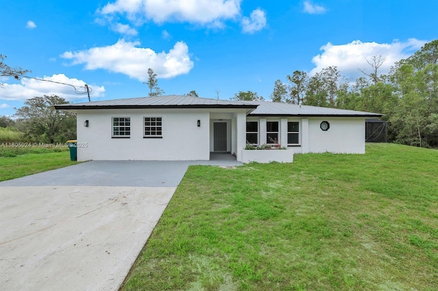 3973 4th Ave SE, Naples, FL 34117 - view of front of property featuring stucco siding, concrete driveway, a front lawn, and metal roof
