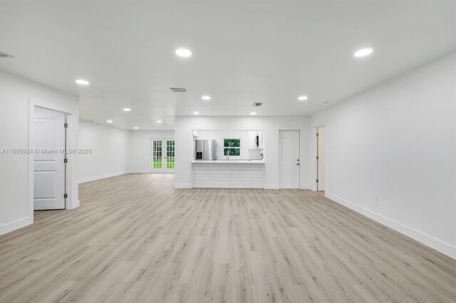 3973 4th Ave SE, Naples, FL 34117 - unfurnished living room featuring recessed lighting, light wood-style flooring, and baseboards