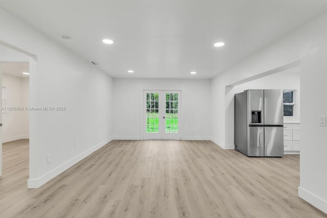 3973 4th Ave SE, Naples, FL 34117 - unfurnished living room featuring light wood-style flooring, baseboards, and recessed lighting