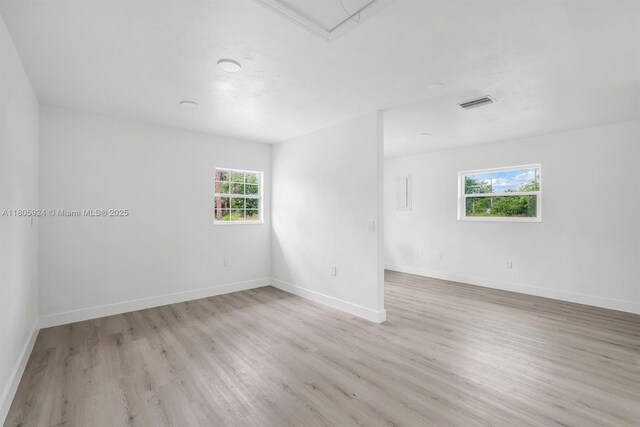 3973 4th Ave SE, Naples, FL 34117 - spare room with light wood-style floors, plenty of natural light, and baseboards
