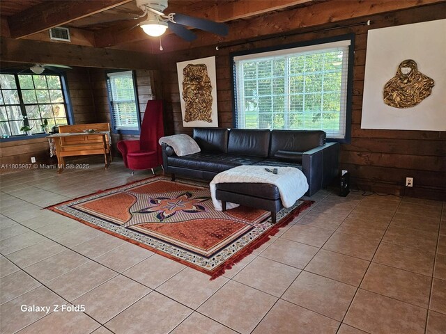 4070 E River Ft, Myers, FL 33916 - tiled living area with wooden walls, ceiling fan, and beam ceiling