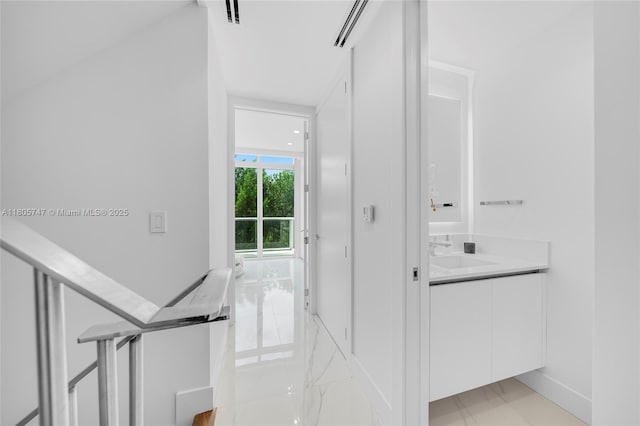 100 S Pointe Dr Unit Th-13, Miami Beach, FL 33139 - hallway featuring a sink and light marble finish flooring