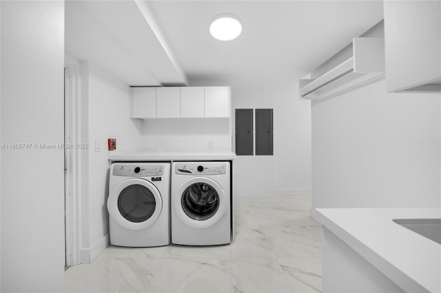 100 S Pointe Dr Unit Th-13, Miami Beach, FL 33139 - laundry room featuring washing machine and dryer, light marble finish flooring, and cabinet space