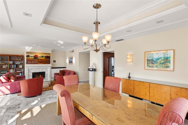 610 Valencia Ave Unit 503, Coral Gables, FL 33134 - dining room featuring a raised ceiling, ornamental molding, a chandelier, and a high end fireplace