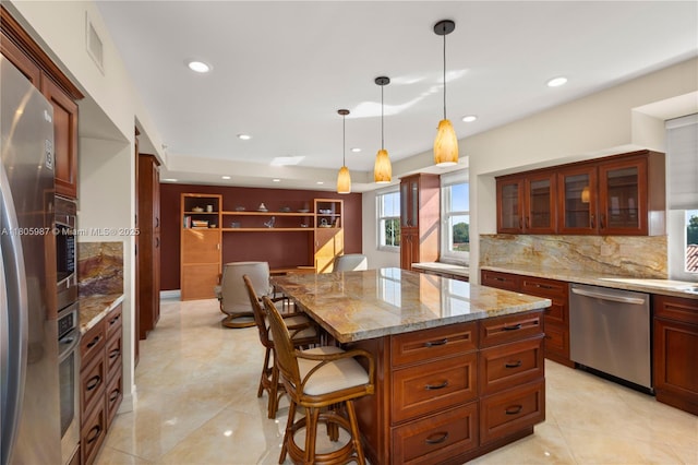 610 Valencia Ave Unit 503, Coral Gables, FL 33134 - kitchen featuring stainless steel appliances, a breakfast bar area, glass insert cabinets, recessed lighting, and decorative backsplash